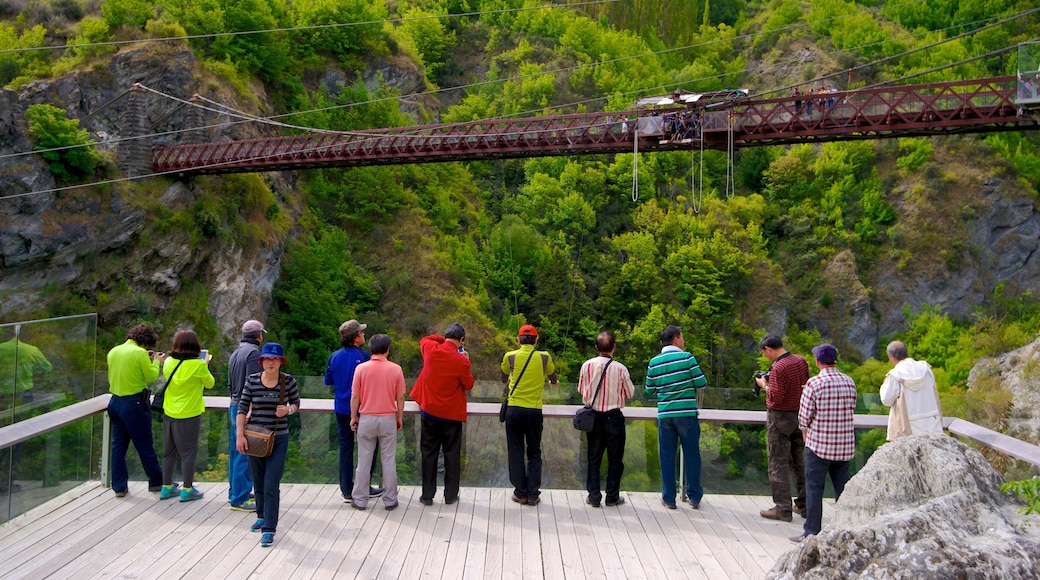 Kawarau Suspension Bridge featuring hiking or walking, a bridge and views