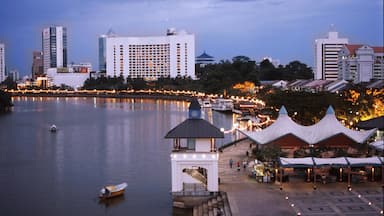 Kuching showing a skyscraper, a coastal town and a bay or harbor