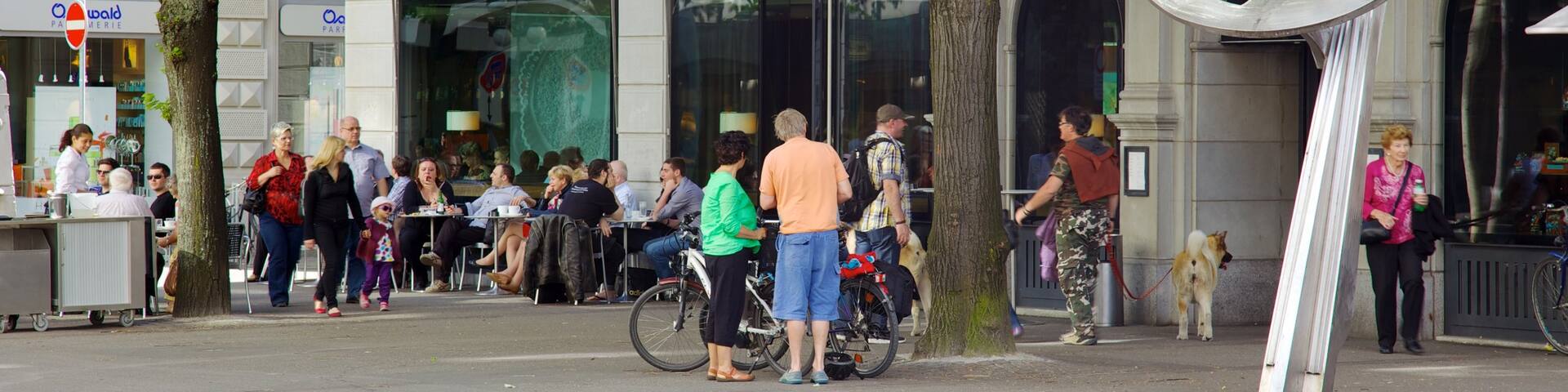 Paradeplatz showing cycling and street scenes as well as a large group of people