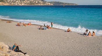 Les Baumettes showing general coastal views and a sandy beach as well as a small group of people