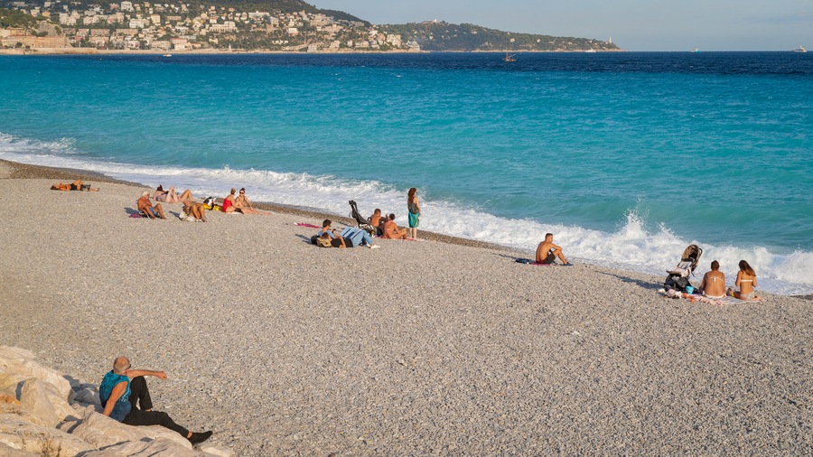 Les Baumettes showing general coastal views and a sandy beach as well as a small group of people