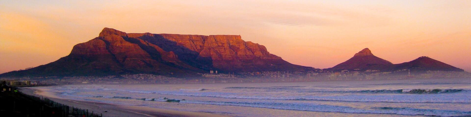 Table Mountain showing mountains, a sunset and a sandy beach