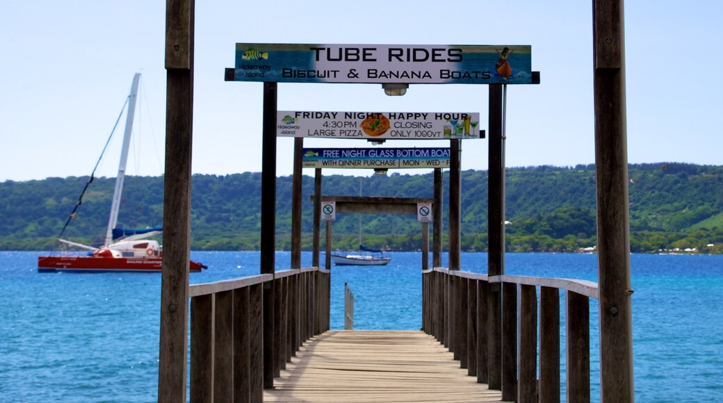 Mele Bay which includes a bay or harbor, signage and boating