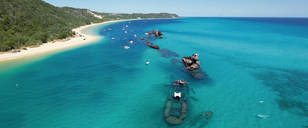 Tangalooma which includes tropical scenes, a beach and landscape views