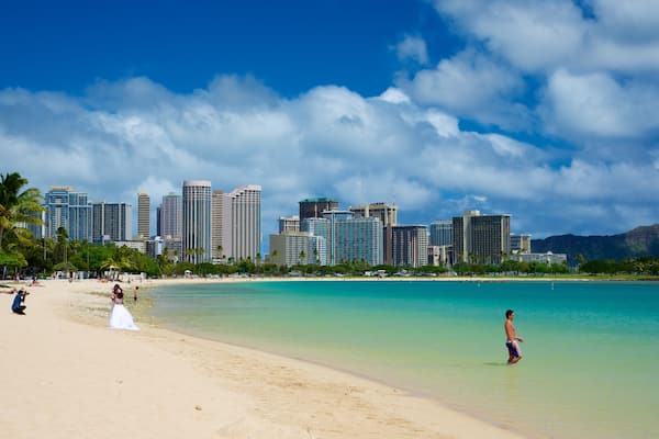 Ala Moana Beach Park featuring a coastal town, tropical scenes and modern architecture