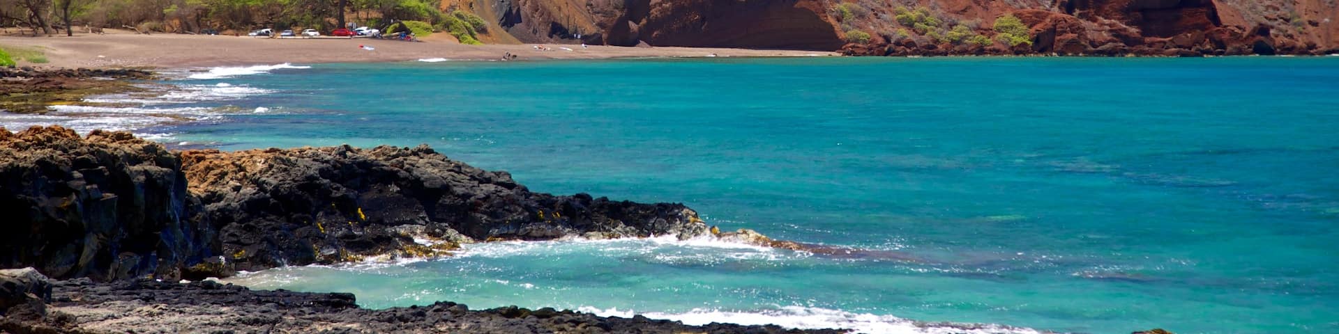 Maluaka Beach featuring rocky coastline, mountains and landscape views