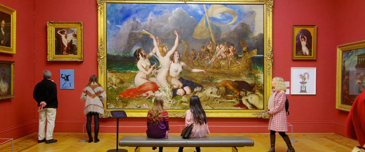 Manchester Art Gallery showing interior views and art as well as a small group of people