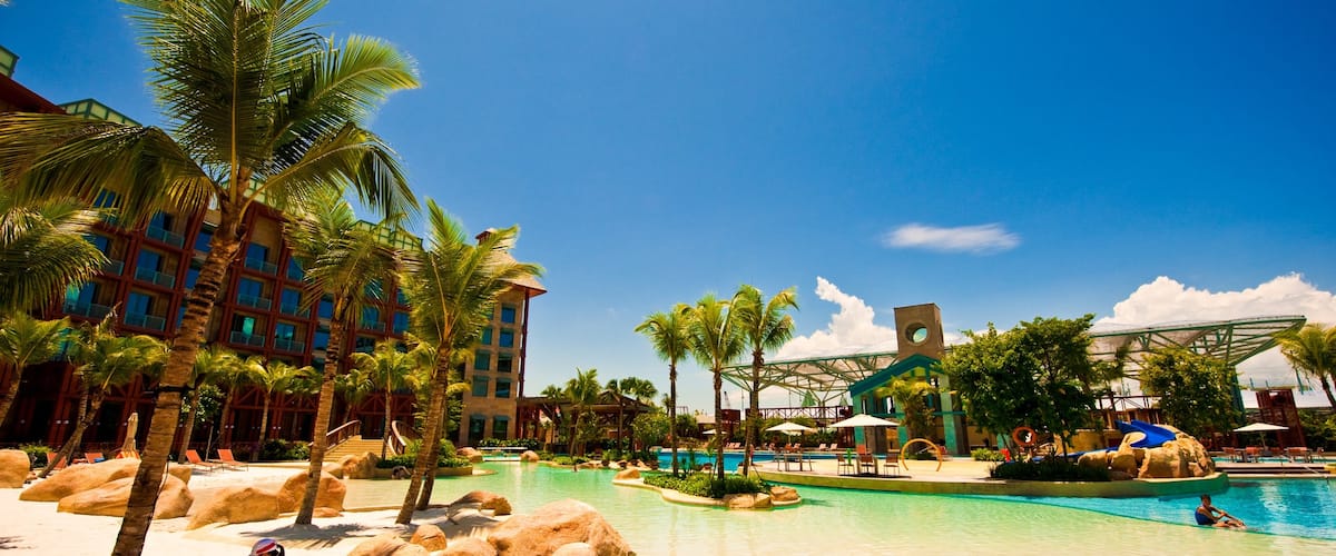 Sentosa featuring swimming, a sandy beach and a coastal town