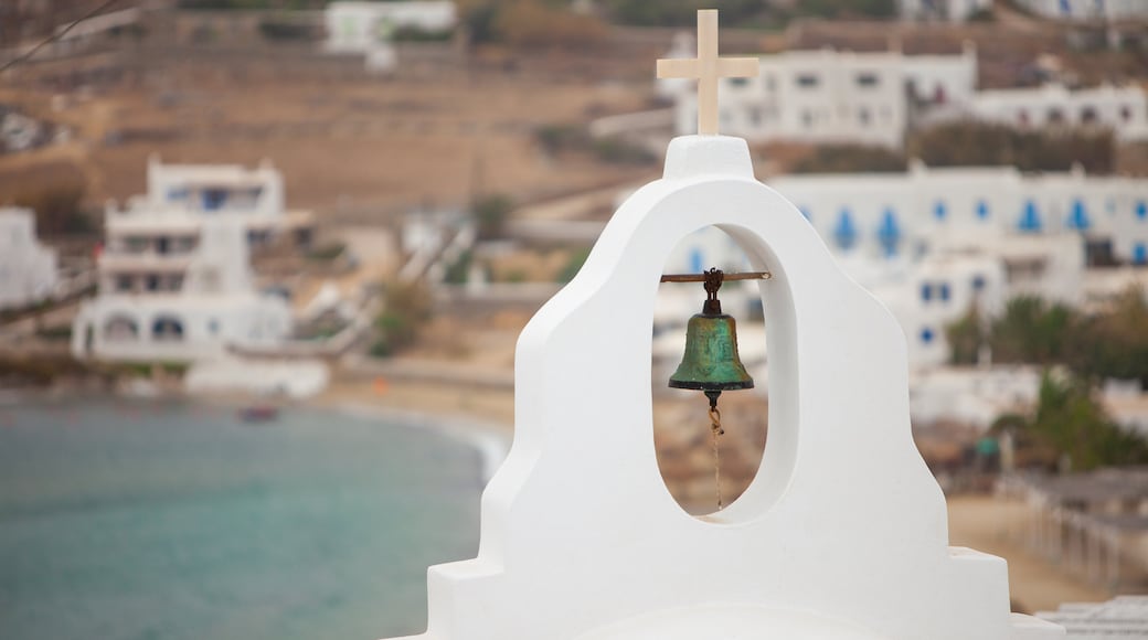 Ornos showing a church or cathedral, general coastal views and heritage architecture