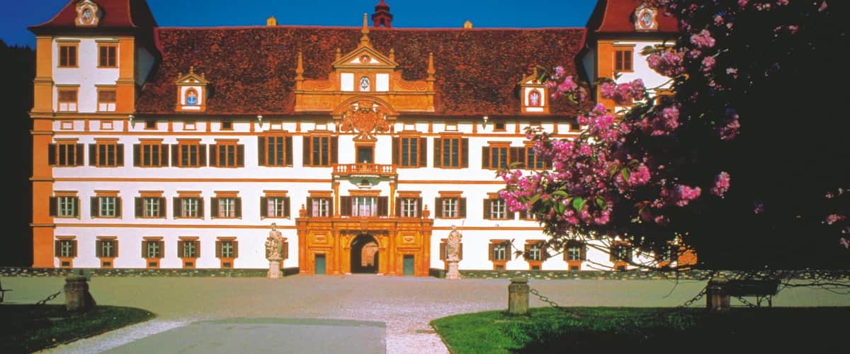 Eggenberg Palace which includes a square or plaza, flowers and chateau or palace