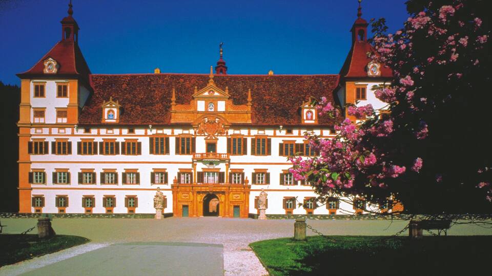 Eggenberg Palace which includes a square or plaza, flowers and chateau or palace