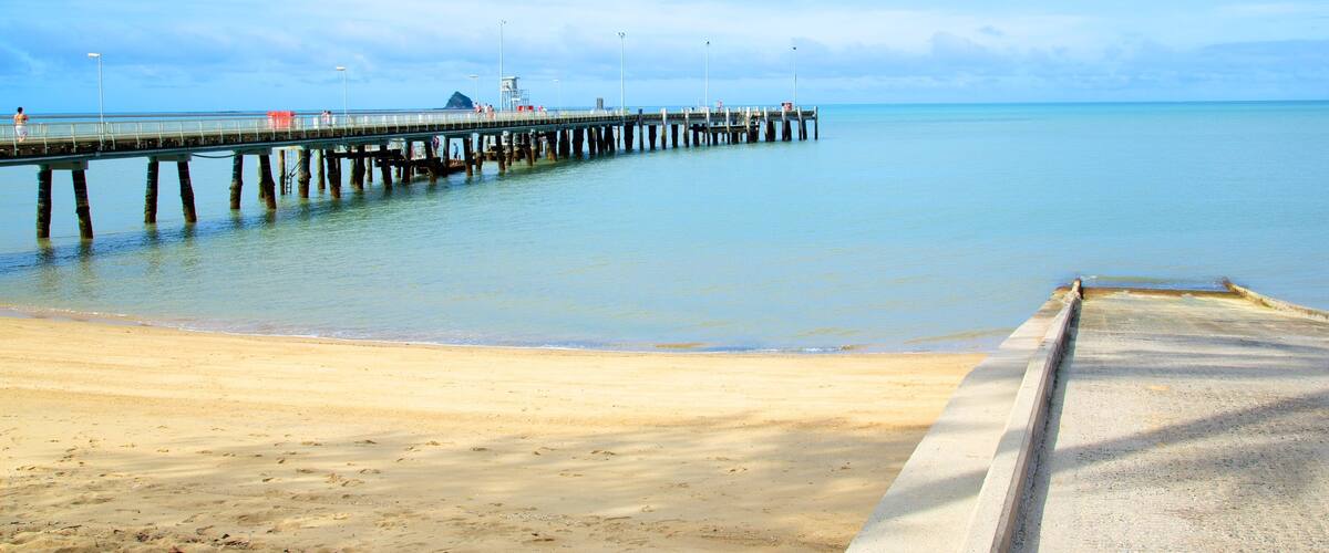 Palm Cove Beach featuring skyline, a sandy beach and landscape views