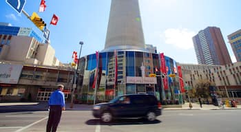 Calgary Tower showing a city and street scenes as well as an individual male