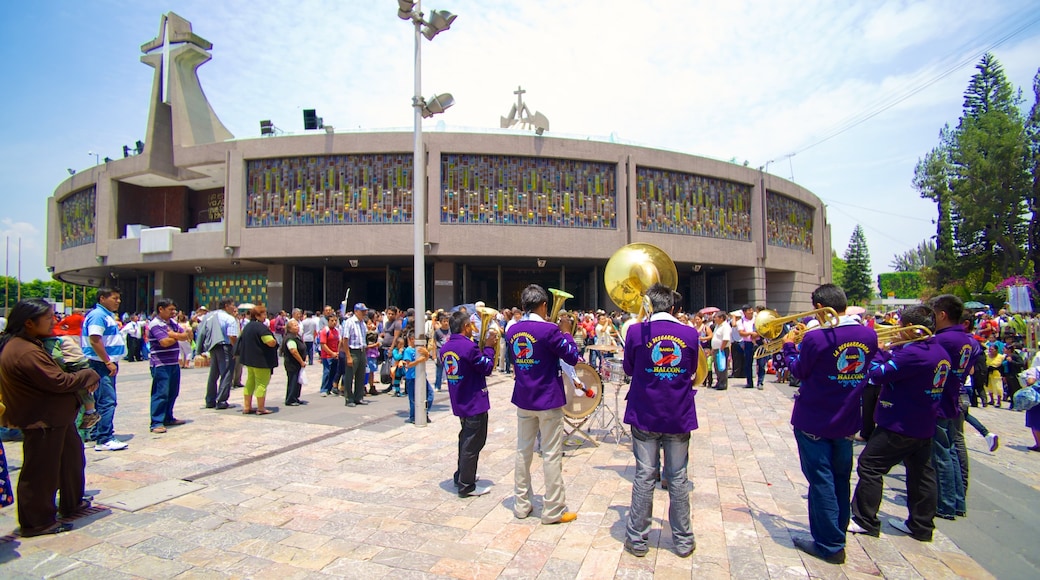 Basilica of Our Lady of Guadalupe showing street performance, religious elements and a church or cathedral