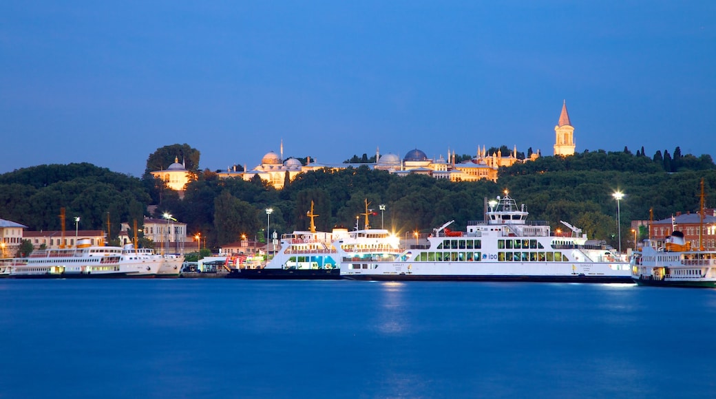 Galata Tower featuring a ferry, a bay or harbour and night scenes