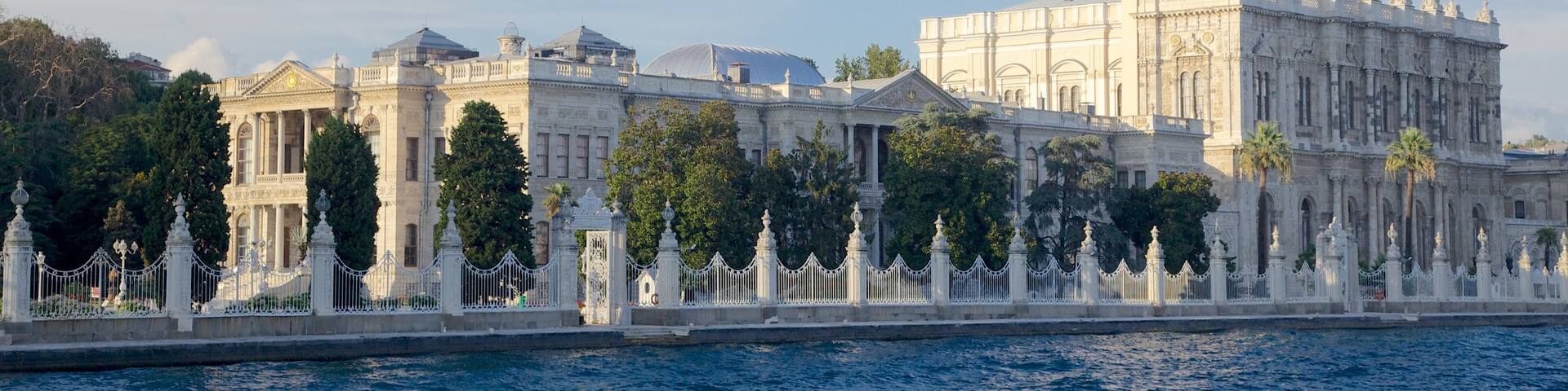 Dolmabahce Palace which includes château or palace, heritage architecture and a river or creek