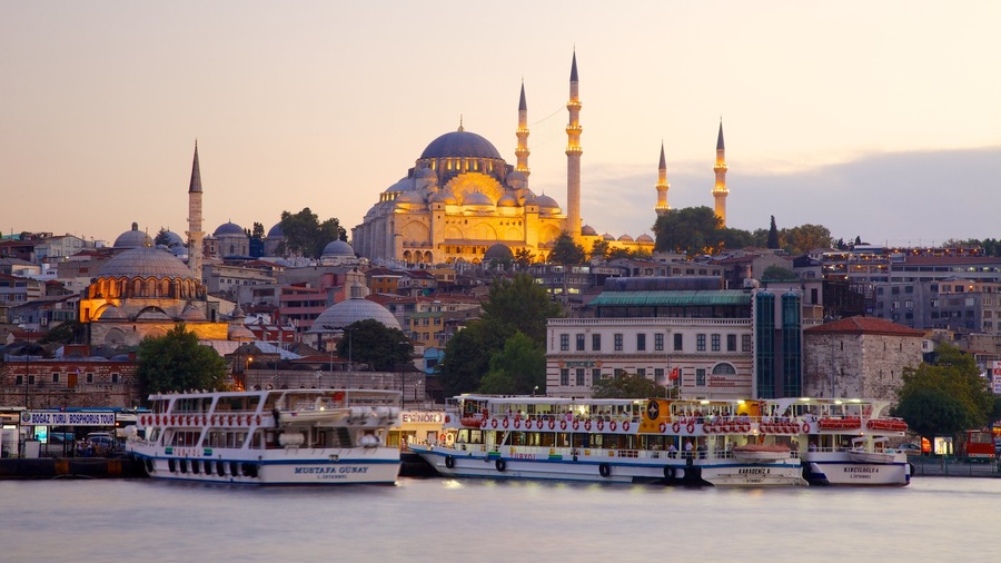 Rustem Pasha Mosque showing a ferry, a bay or harbor and a sunset