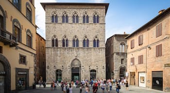 Palazzo Tolomei showing heritage architecture and street scenes as well as a small group of people