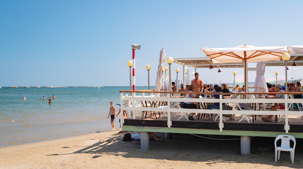 Cesenatico which includes a sandy beach and general coastal views as well as a small group of people