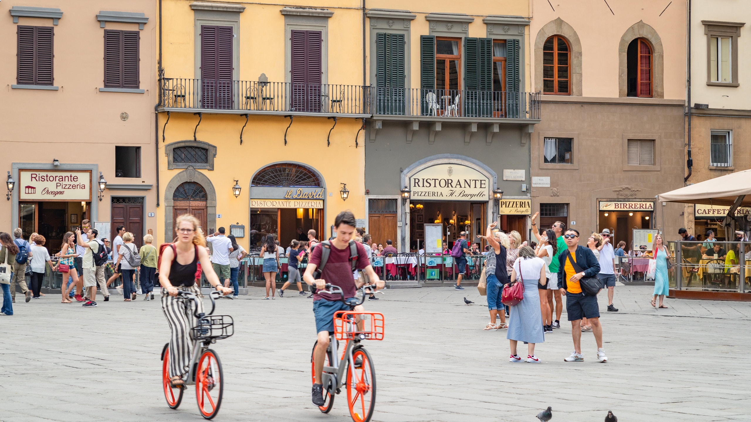 Piazza della Signoria which includes cycling and street scenes as well as a couple