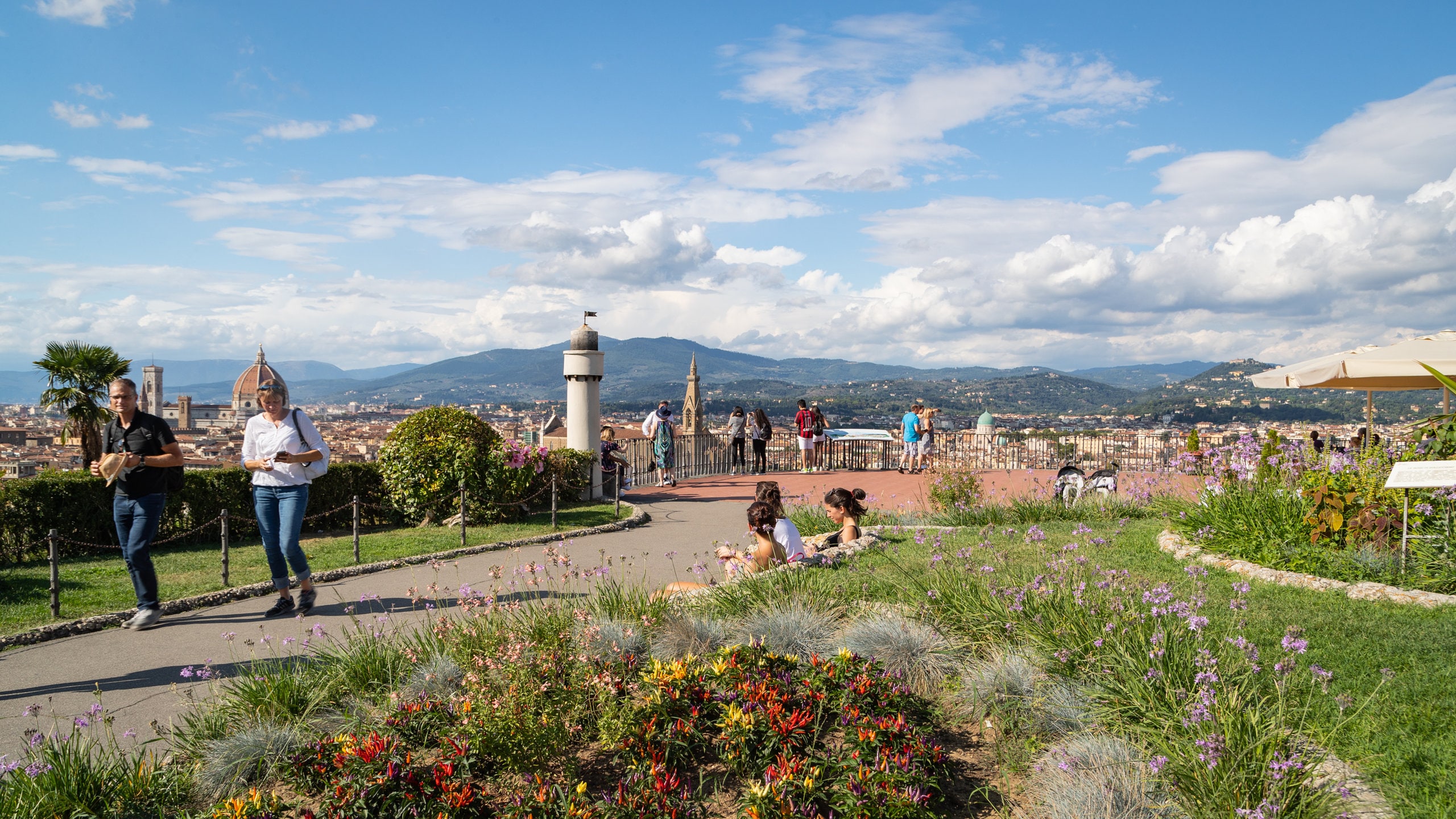 Piazzale Michelangelo featuring flowers and a garden as well as a couple