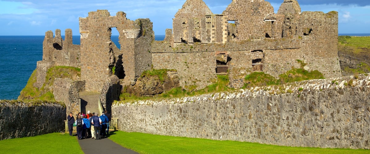 Dunluce Castle which includes heritage elements and a ruin as well as a small group of people