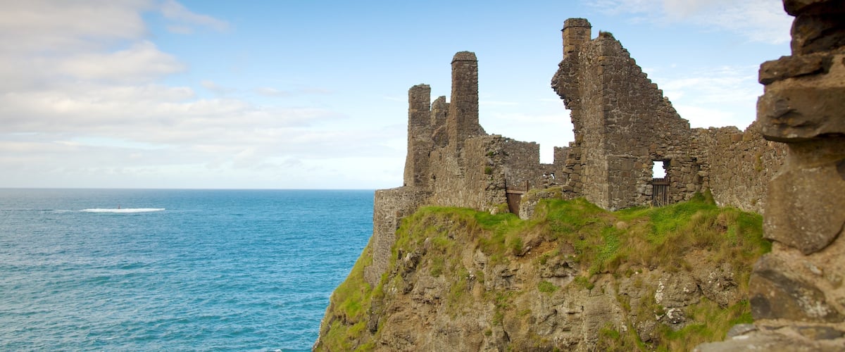 Dunluce Castle which includes general coastal views, building ruins and heritage elements
