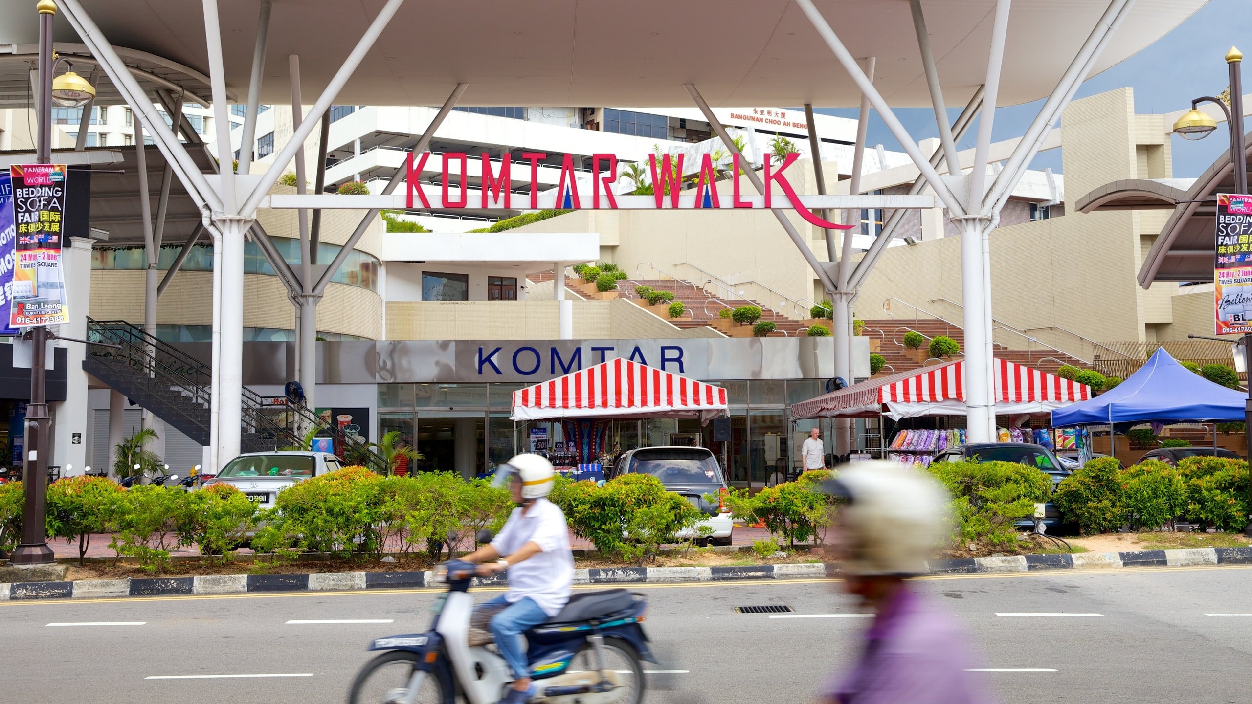 KOMTAR showing signage, street scenes and motorbike riding