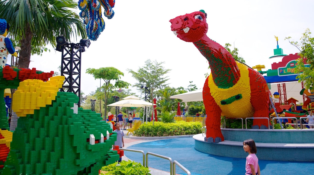 Johor Bahru showing rides and a statue or sculpture as well as an individual child