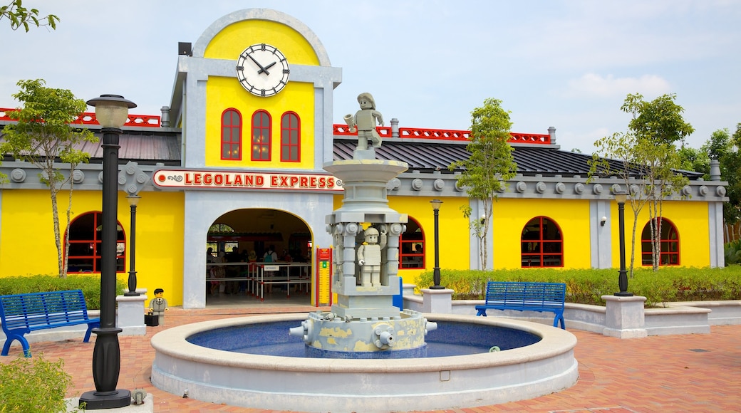 Johor Bahru showing a fountain, rides and signage