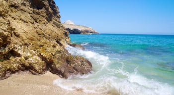 Puerto Vallarta featuring rocky coastline, waves and a beach