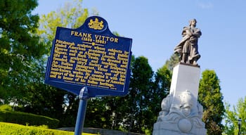 Schenley Park showing signage, a memorial and a statue or sculpture