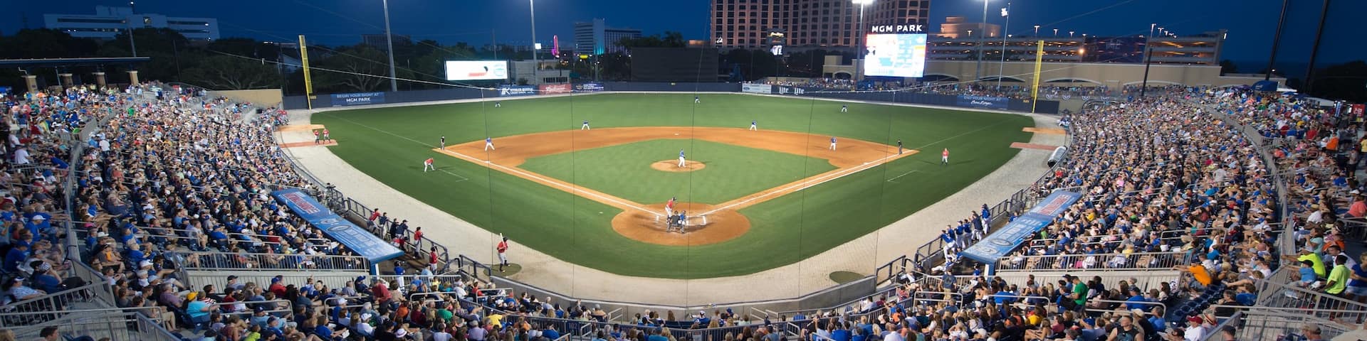 Biloxi featuring a sporting event and night scenes as well as a large group of people