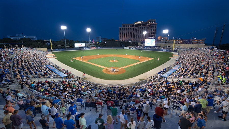Biloxi featuring a sporting event and night scenes as well as a large group of people