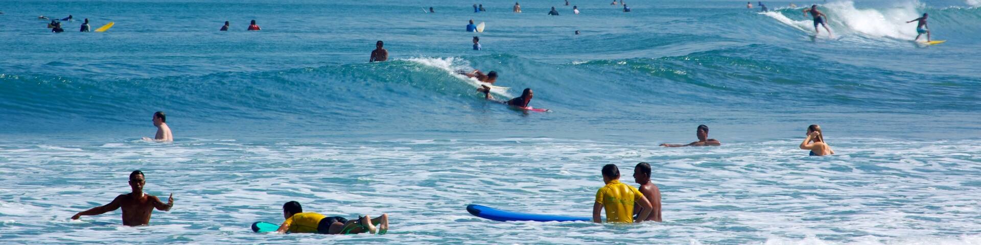 Kuta Beach showing swimming, surfing and surf
