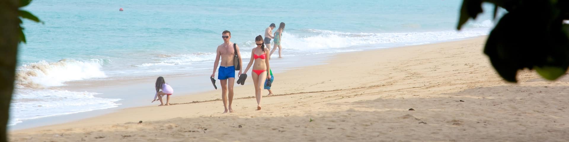 Nusa Dua Beach featuring a beach as well as a small group of people