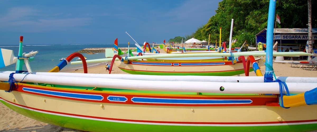Segara Beach which includes tropical scenes, a sandy beach and boating
