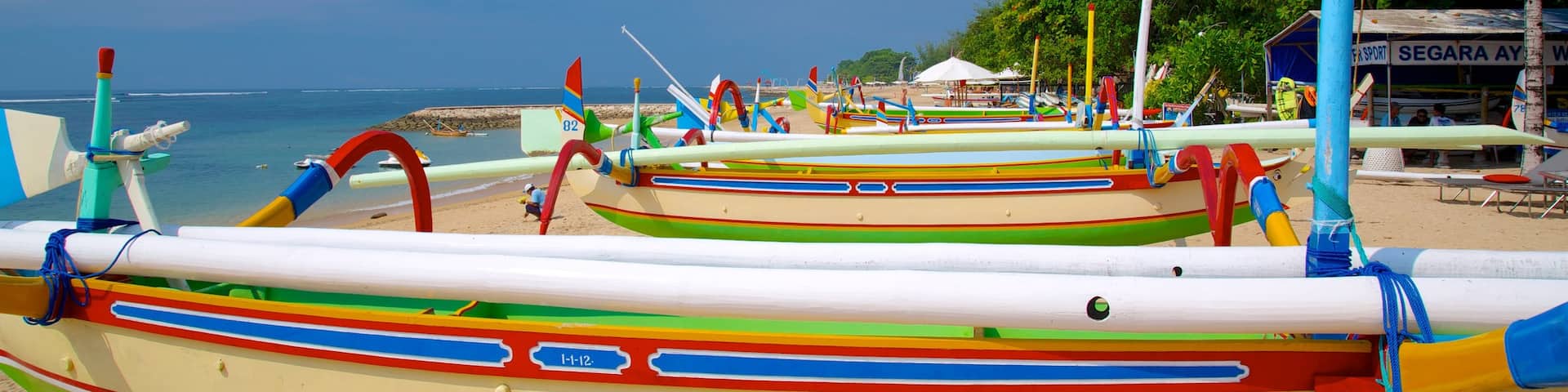 Segara Beach which includes boating, a beach and tropical scenes