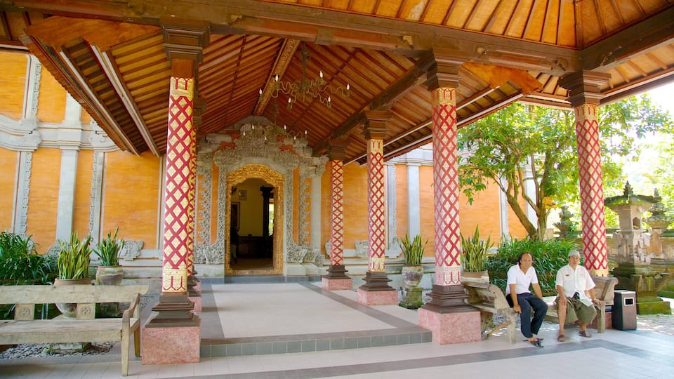 Agung Rai Museum of Art showing religious elements and a temple or place of worship as well as a small group of people