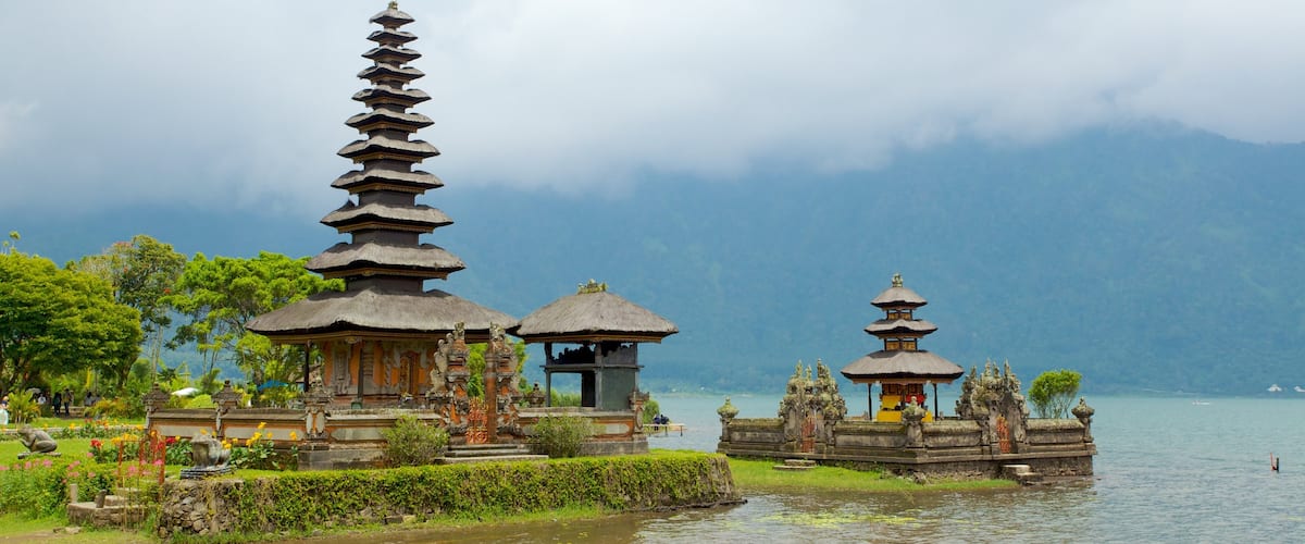 Ulun Danu Temple which includes a temple or place of worship, religious elements and general coastal views