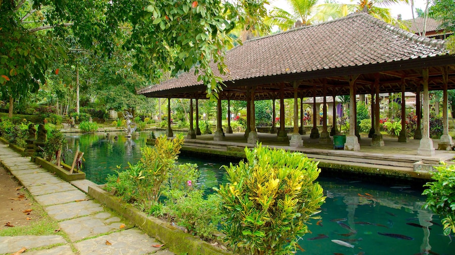 Gunung Kawi Temple featuring religious elements, a pond and a temple or place of worship
