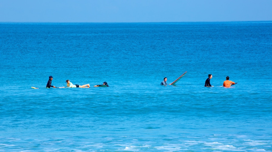 Legian Beach showing surf and surfing as well as a large group of people