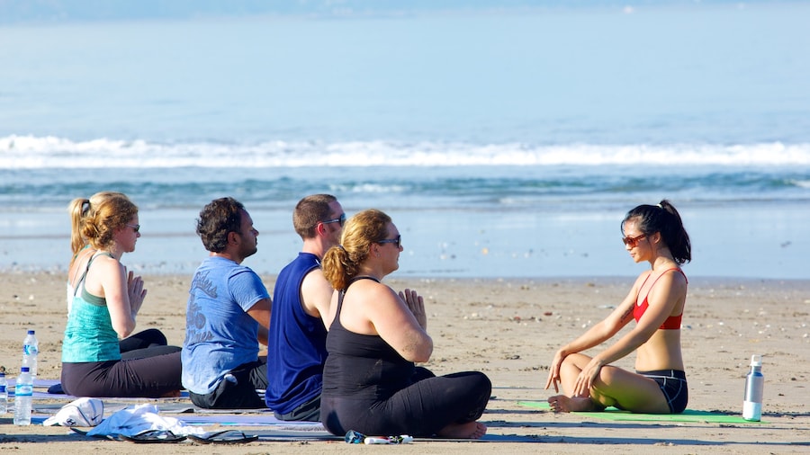 Seminyak which includes a sandy beach and a day spa as well as a large group of people