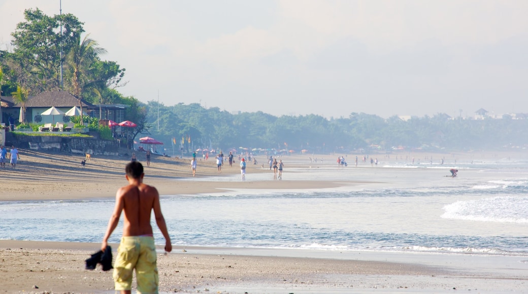 Seminyak which includes a sandy beach as well as an individual male