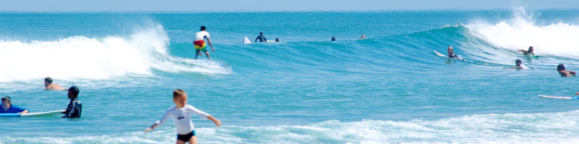 Double Six Beach showing surf and surfing as well as an individual child