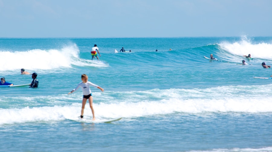 Double Six Beach showing surf and surfing as well as an individual child