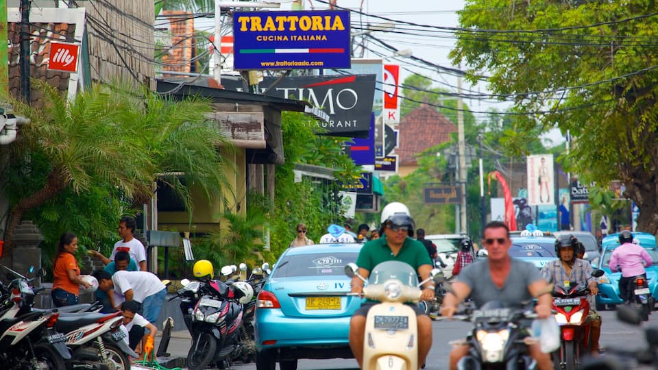 Seminyak which includes motorbike riding, street scenes and a city