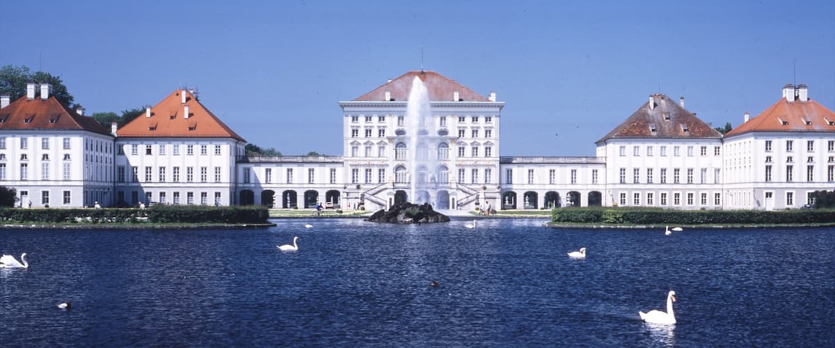 Nymphenburg Palace featuring a pond and château or palace