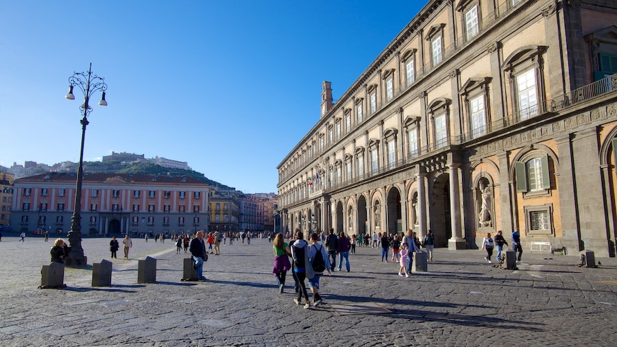 Royal Palace featuring a castle and street scenes as well as a large group of people