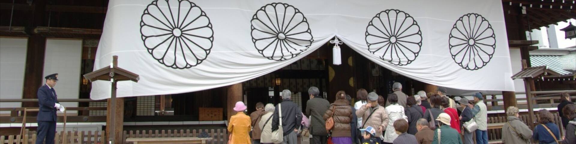 Yasukuni Shrine showing a temple or place of worship and religious elements as well as a large group of people